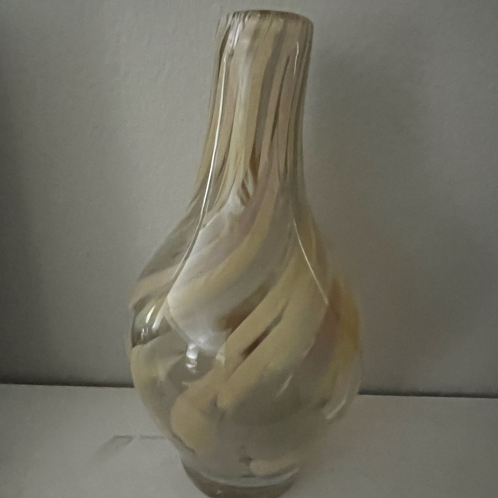 This is a very unique hand blown vase with a sense of movement seen in the swirl